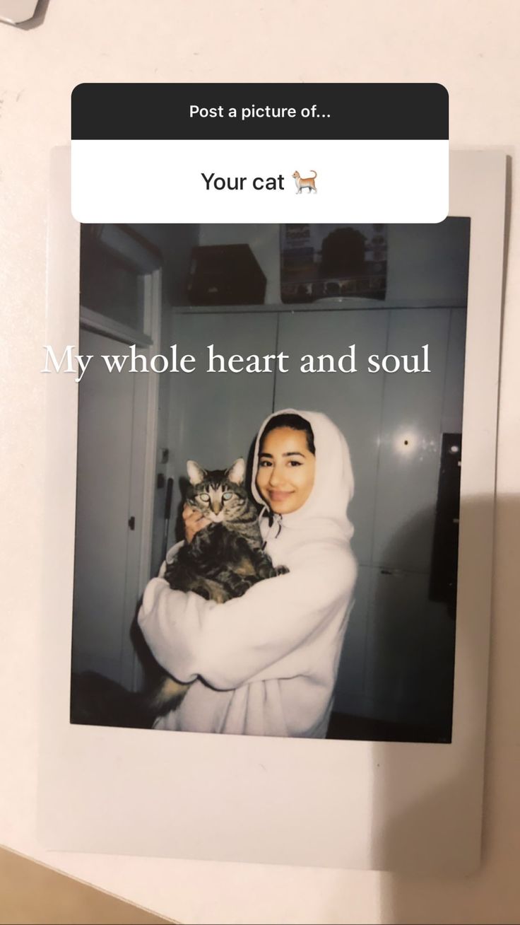 a woman holding a cat in her arms with the caption, my whole heart and soul