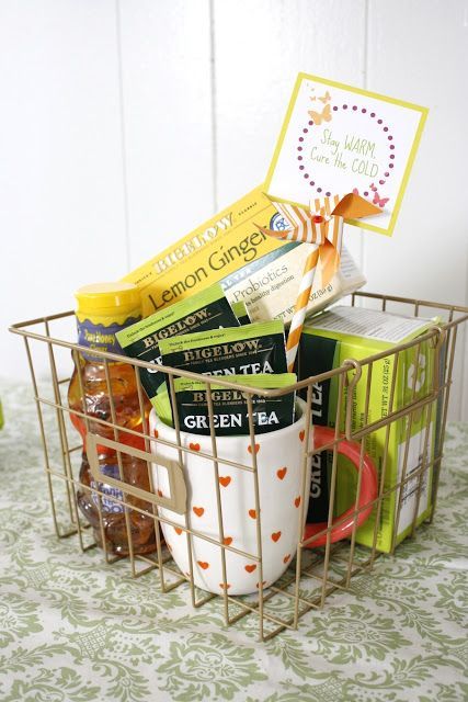 a basket filled with tea and snacks on top of a table