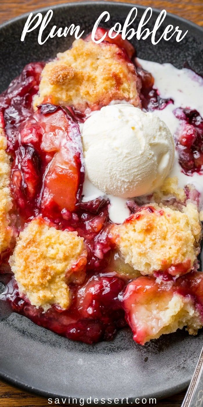 plum cobbler on a plate with ice cream