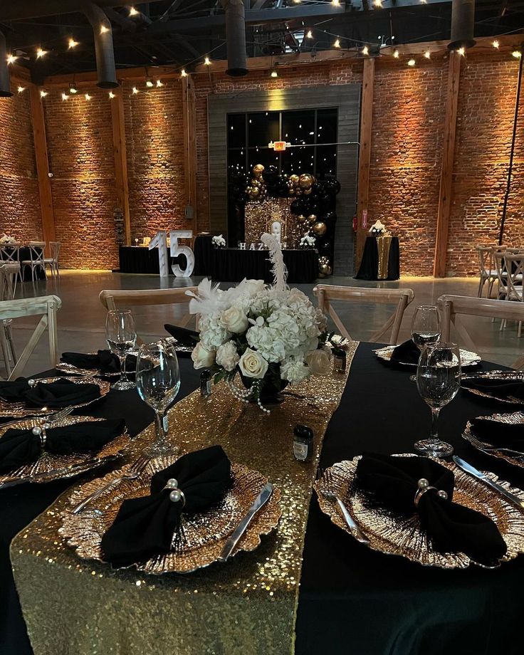 the tables are set with gold sequins and black linens for an elegant event