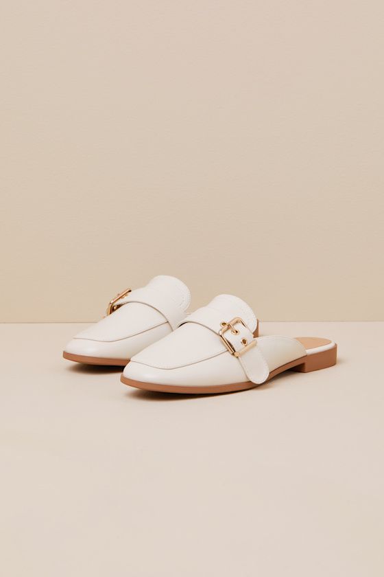 Upgrade your everyday flats with a chic new option like the Lulus Marquete Bone Buckle Mule Slides! These too-cute mules have a smooth, faux leather construction that shapes an almond toe upper and an adjustable strap with a gold buckle and matching grommets. Classic notched collar leads to a slide-on design for effortless styling. 0. 75" rubber heel. Cushioned insole. Rubber sole has nonskid markings. Man made materials. Imported. Lulus | Marquete Bone Buckle Mule Slides | Size 10. Spring Faux Leather Closed Toe Slip-ons, Beige Faux Leather Flats For Spring, Spring Beige Faux Leather Flats, Spring Season Beige Faux Leather Flats, Chic Synthetic Flat Slip-ons, Spring Closed-toe Faux Leather Slip-ons, Trendy Beige Flat Mules, Elegant Spring Faux Leather Flats, Trendy Flat Heel Mules With Buckle Closure