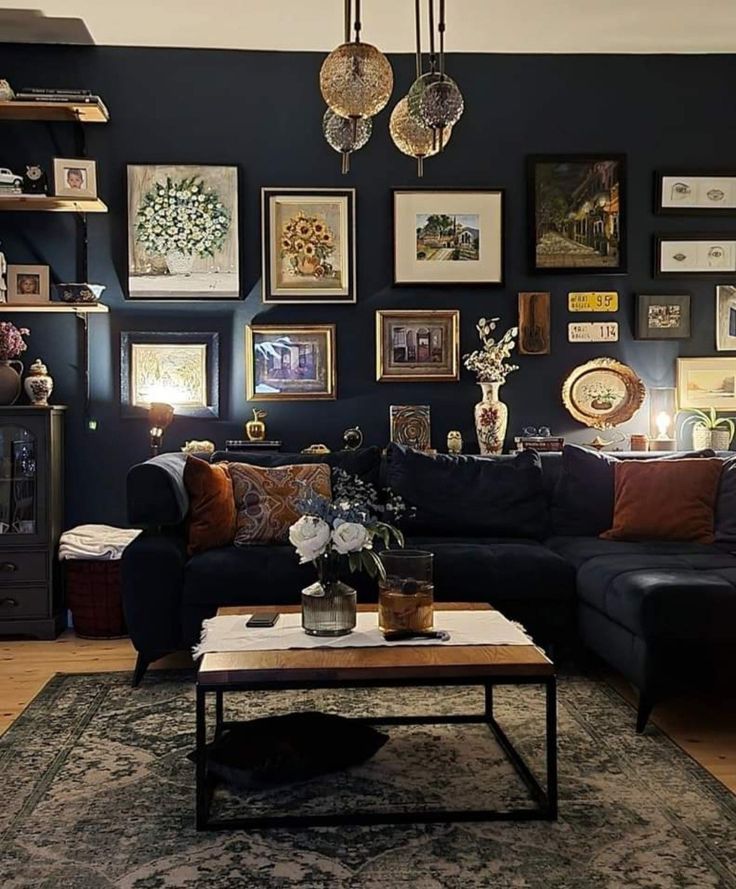 a living room filled with furniture and pictures on the wall