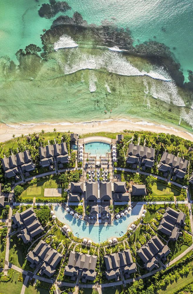 an aerial view of the resort and surrounding area, with water in the foreground