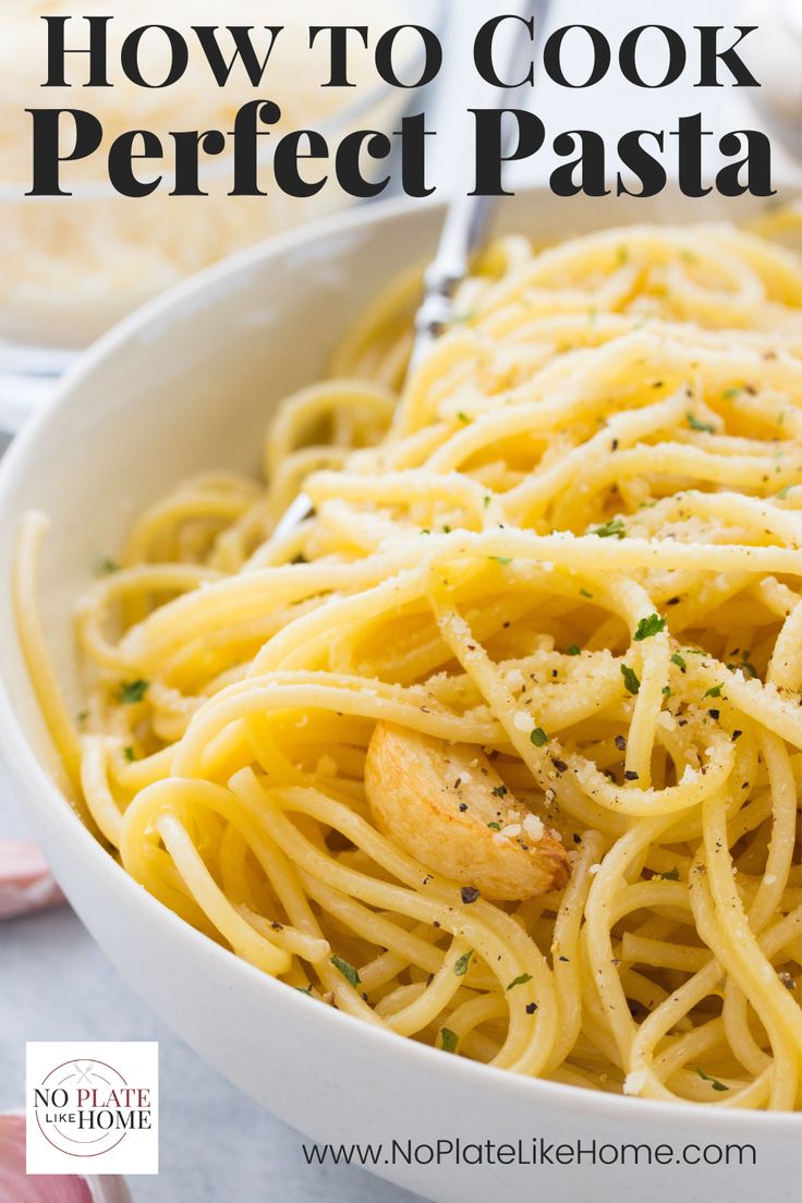 a white bowl filled with pasta and garnished with parmesan sprinkles