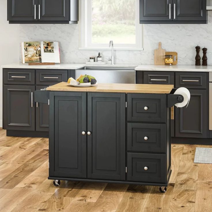 a kitchen with black cabinets and an island