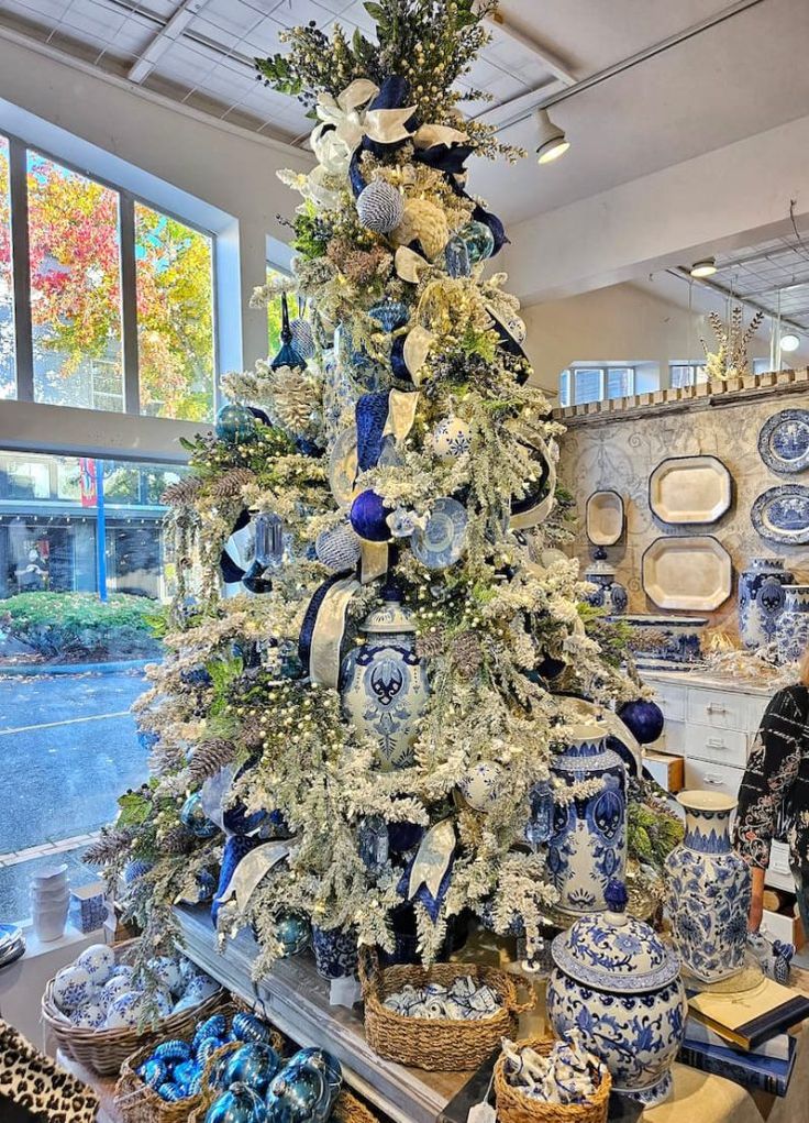 a blue and white christmas tree in a store