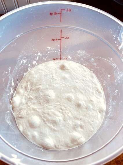 a bowl with dough in it on top of a table