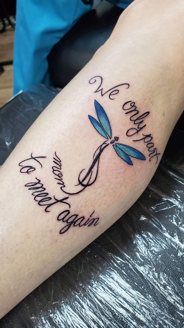 a dragonfly tattoo with the words we love each other on it's arm