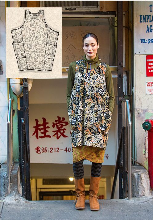 a woman standing in front of a fire hydrant wearing an apron and knee high boots