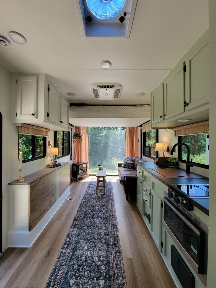 the inside of a camper with an open kitchen and living room area in it