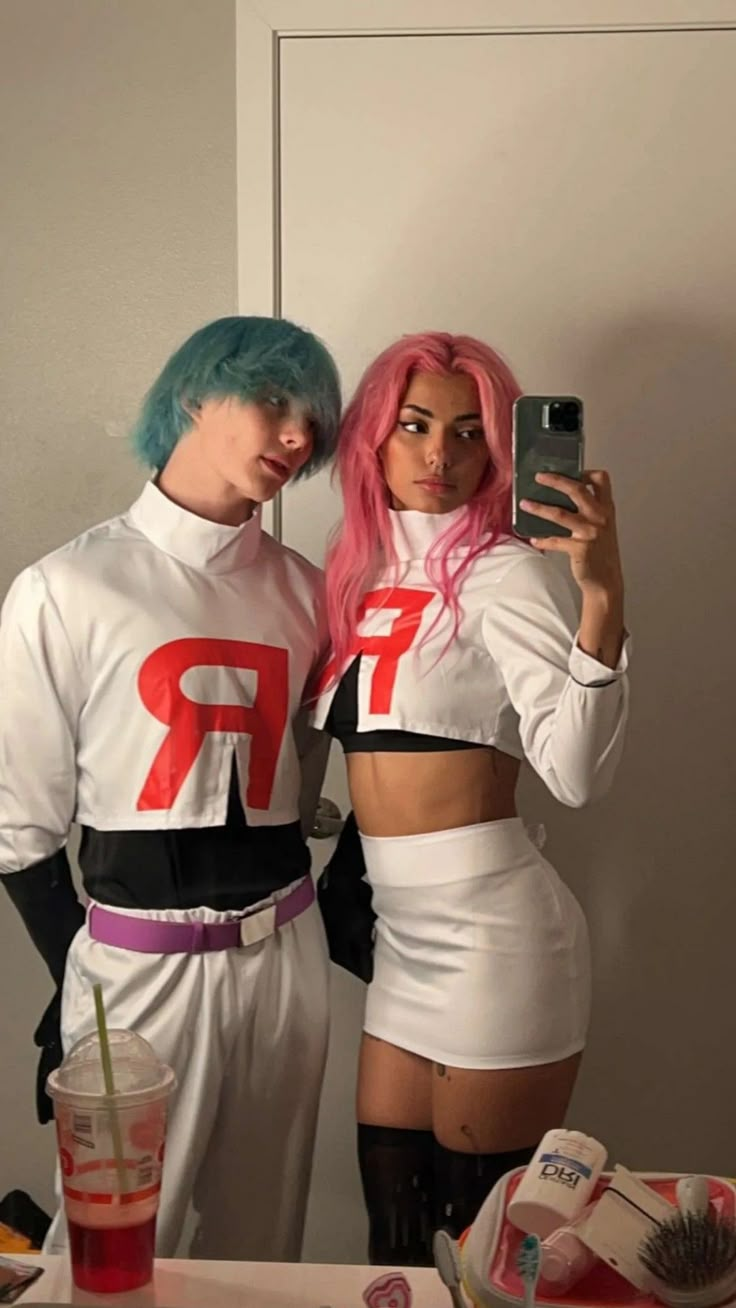 two people dressed up in costumes taking a selfie with a cell phone while standing next to each other