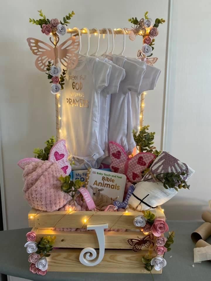 a wooden box filled with lots of items on top of a table next to a wall