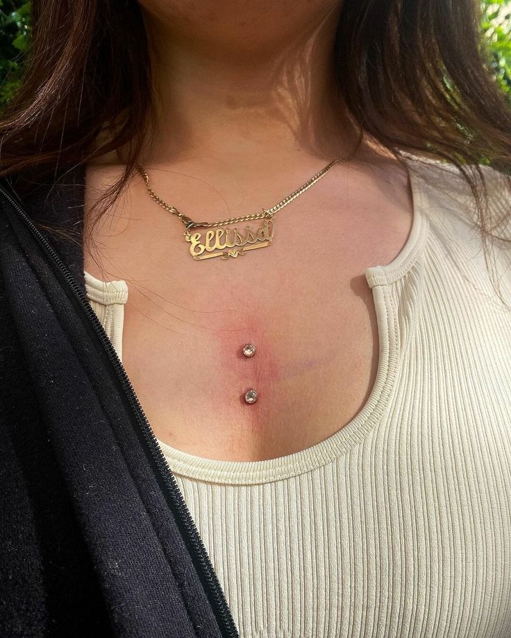 a close up of a woman wearing a necklace with the word boo on it's chest