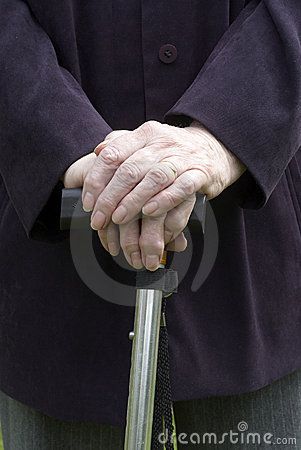 an old woman holding a cane in her hands