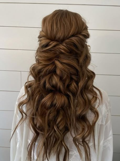 the back of a woman's head with long hair in half - up style