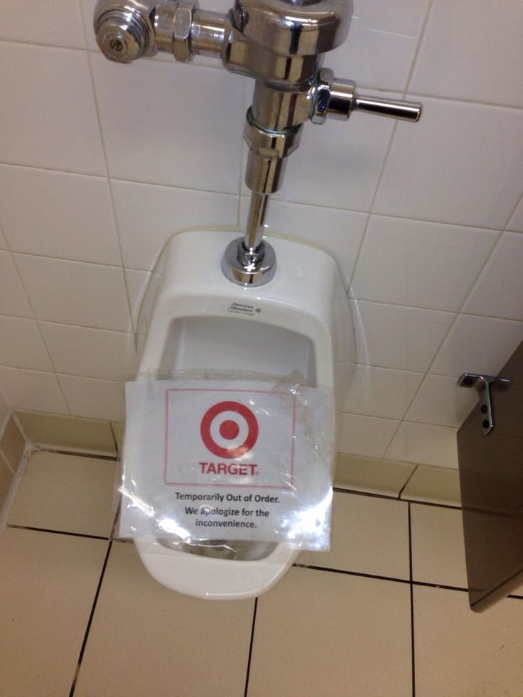 a close up of a urinal with a sign on it that says, tampering