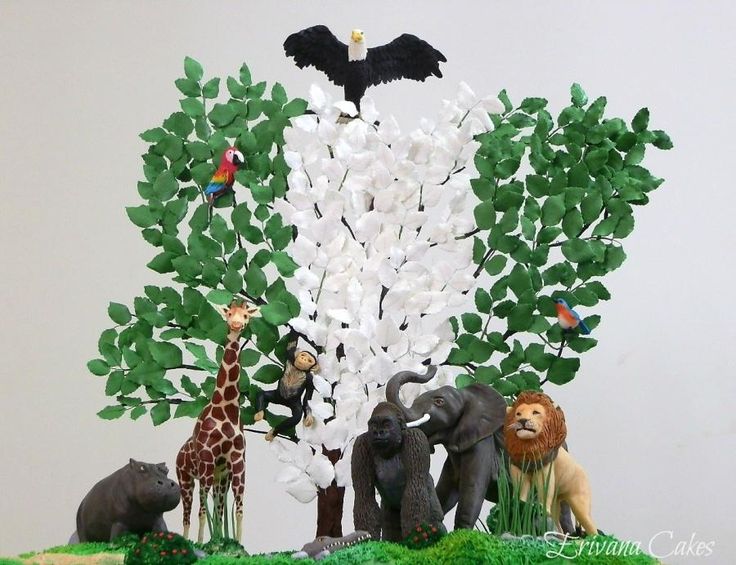 a cake with animals and trees on it