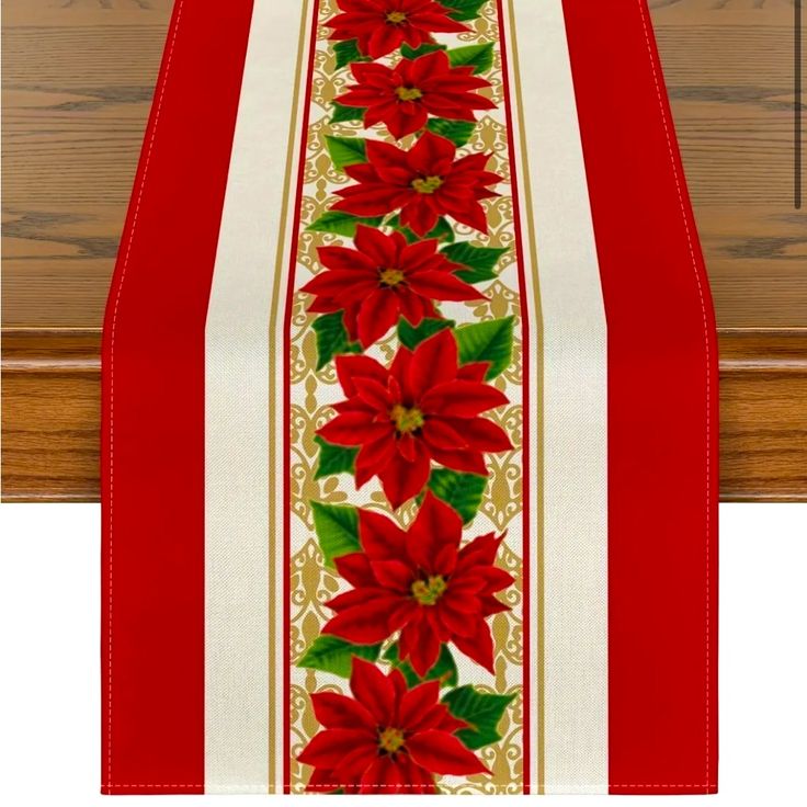 a red and white table runner with poinsettis on it's side