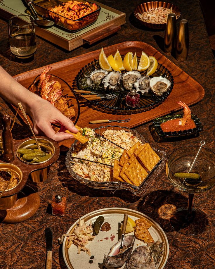 a table full of food including crackers, salads and other foods on it