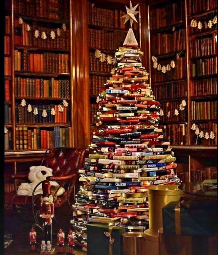 a christmas tree made out of books is in the middle of a room full of books