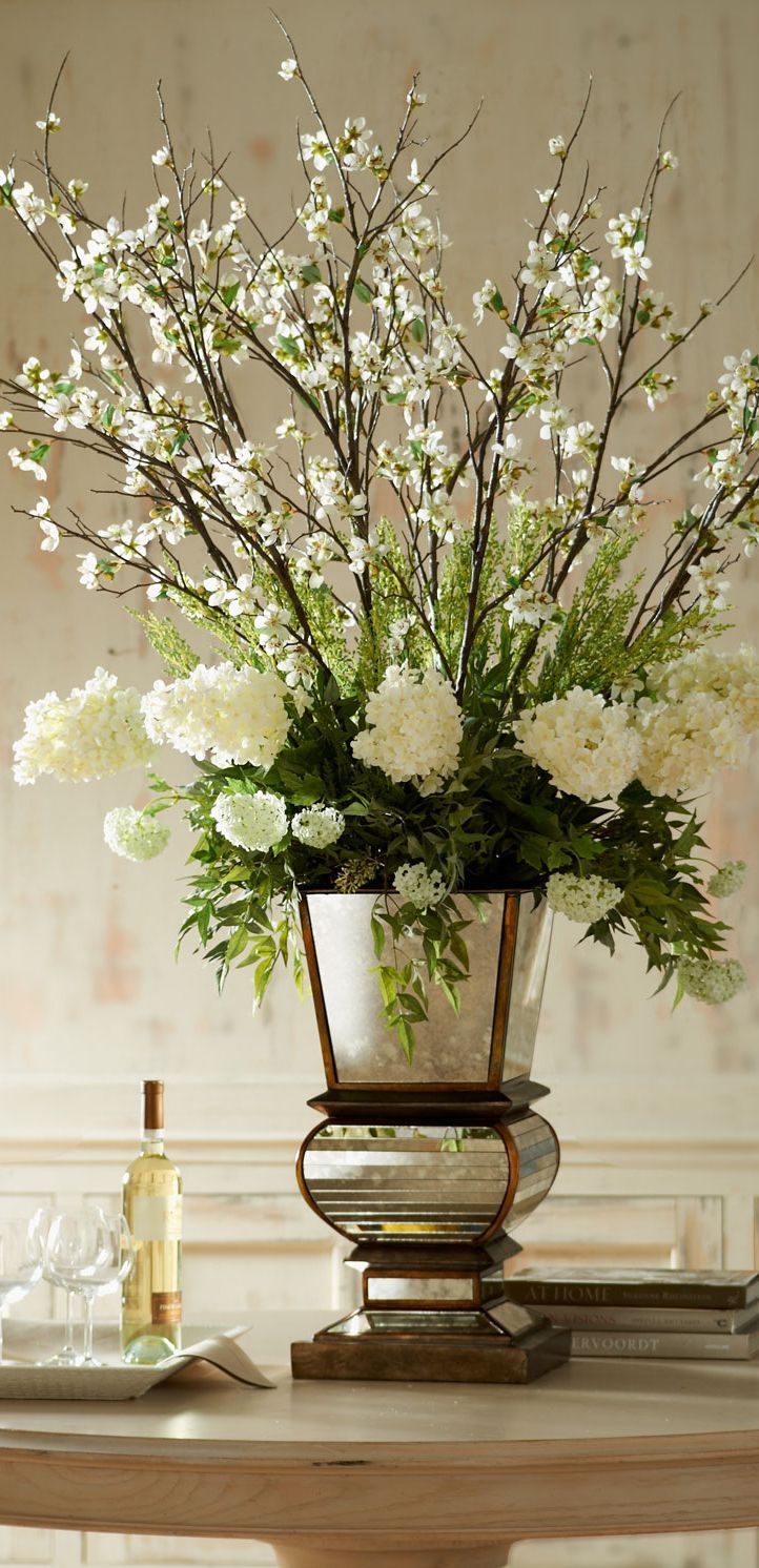 a vase filled with white flowers sitting on top of a table