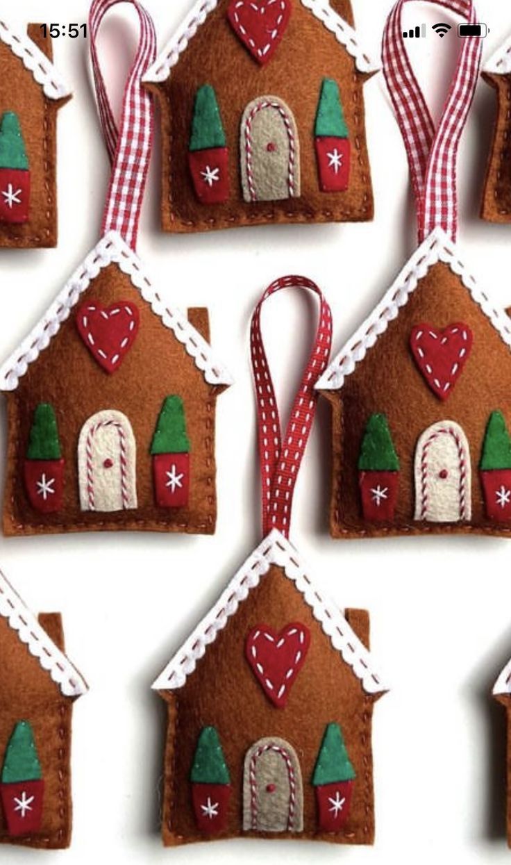 six gingerbread house ornaments are hanging on the wall