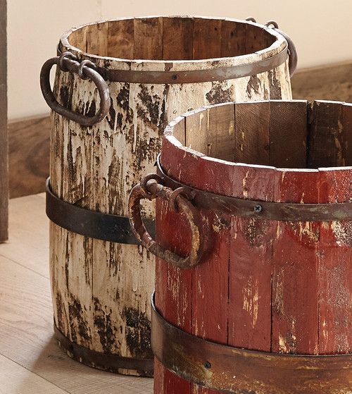 two wooden buckets sitting next to each other