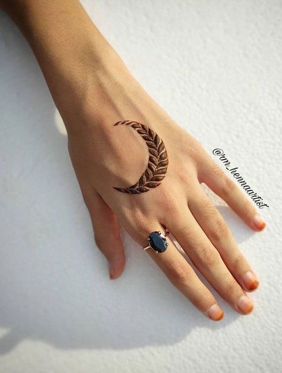 a woman's hand with a ring tattoo on it