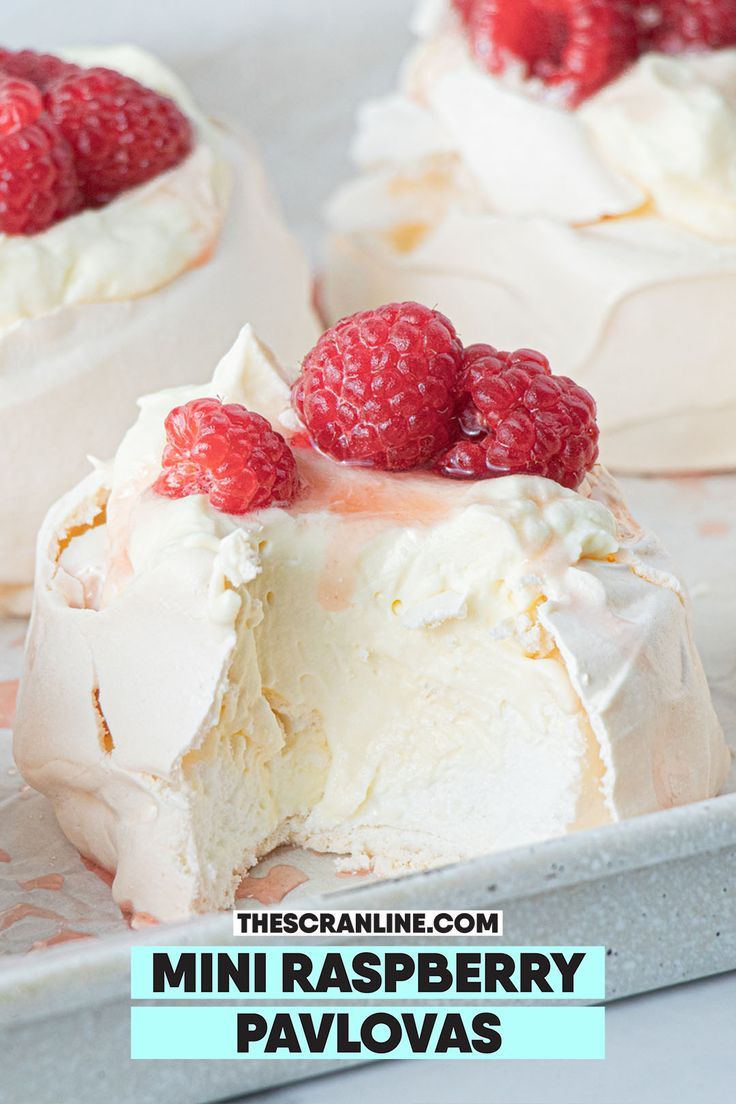 raspberry cheesecake with whipped cream and fresh raspberries on the top