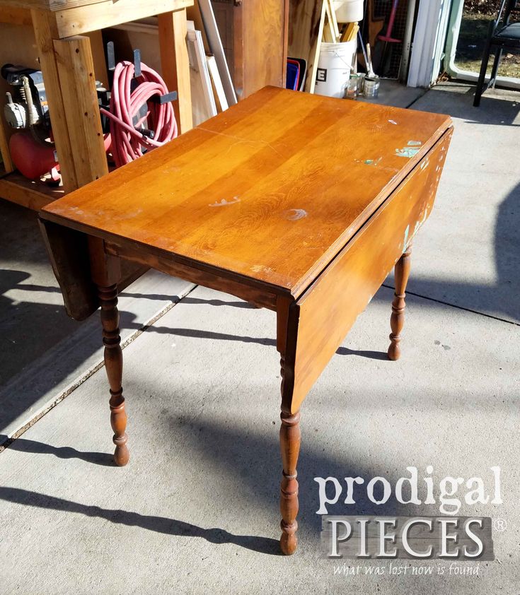 an old wooden table sitting on top of a sidewalk