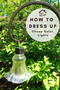 a light that is hanging from a pole in the grass with text overlay reading how to dress up cheap solar lights