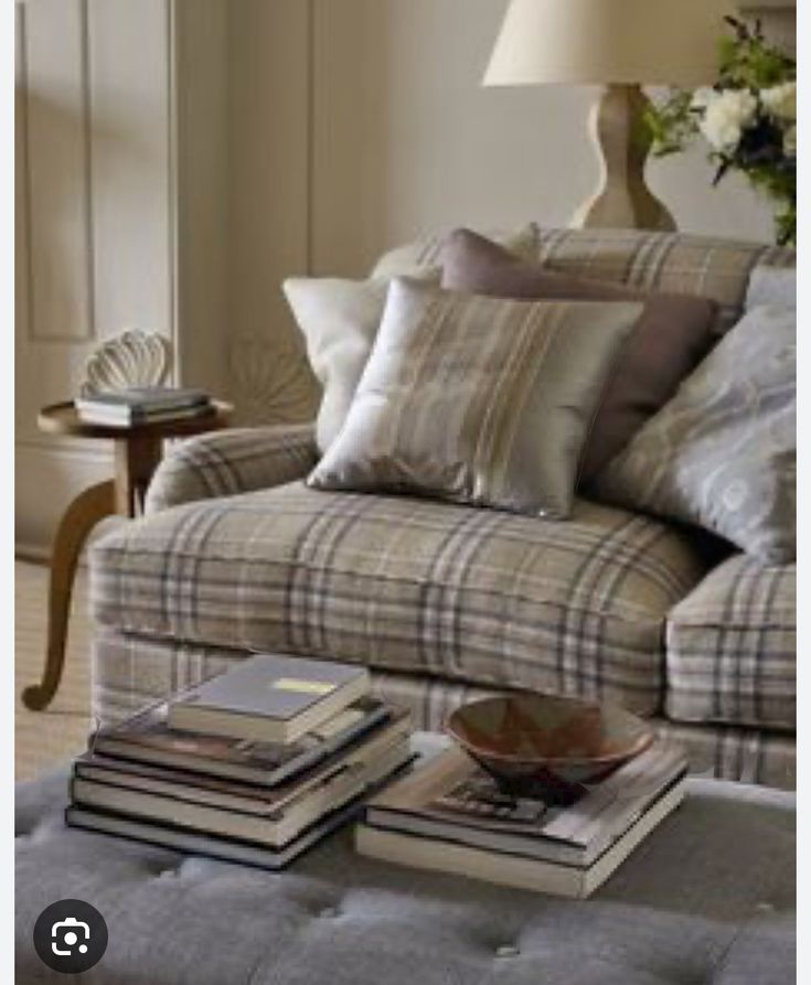 a living room filled with lots of furniture and books on top of a coffee table