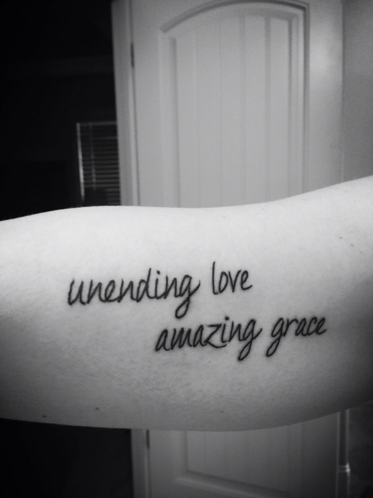 a person with a tattoo that says, unending love is amazing grace