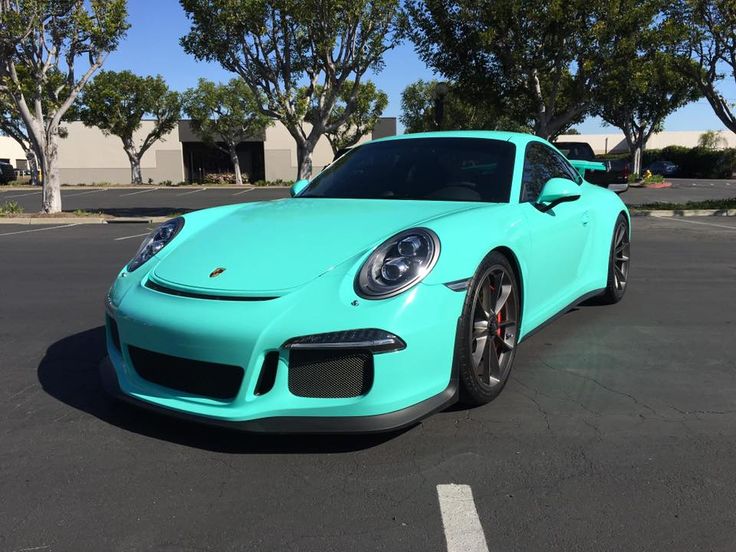 a blue porsche parked in a parking lot