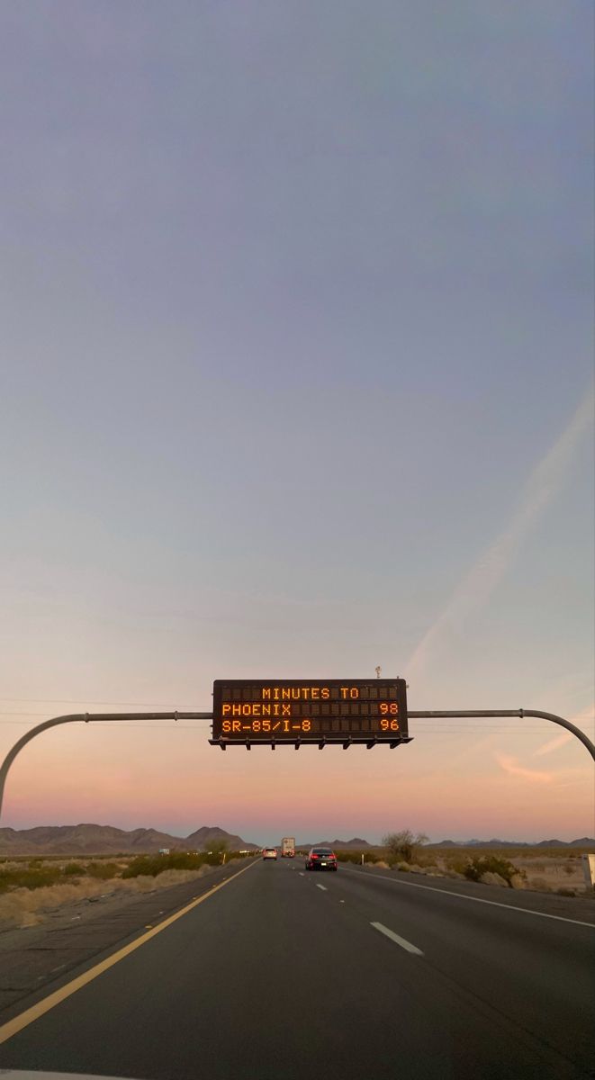 an electronic sign on the side of a road that warns drivers to stop and go