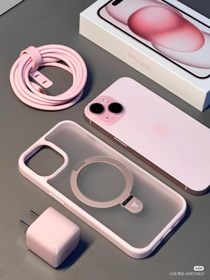 an iphone 11 is shown next to its box and charger, with the charging cord attached