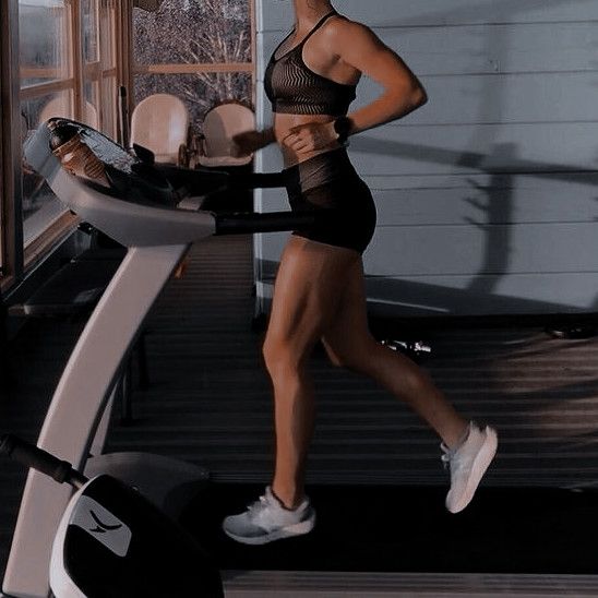 a woman is running on a treadmill