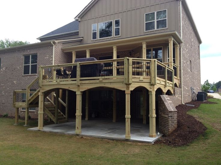 a two story house with an attached deck