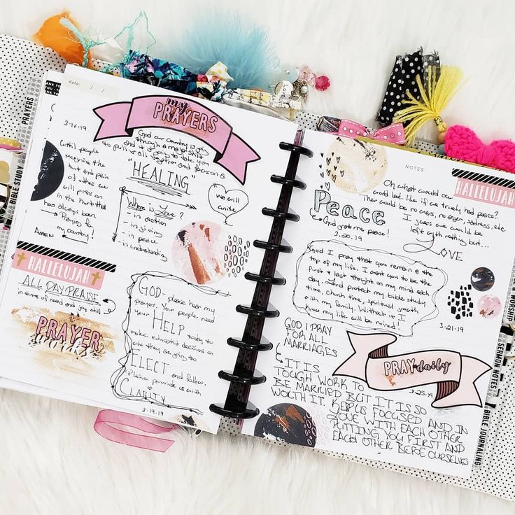 an open notebook with writing on it and lots of other things in the pages next to it