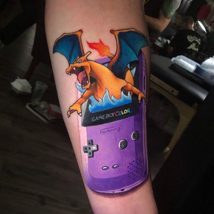 a person with a tattoo on their arm has a gameboy design on his arm