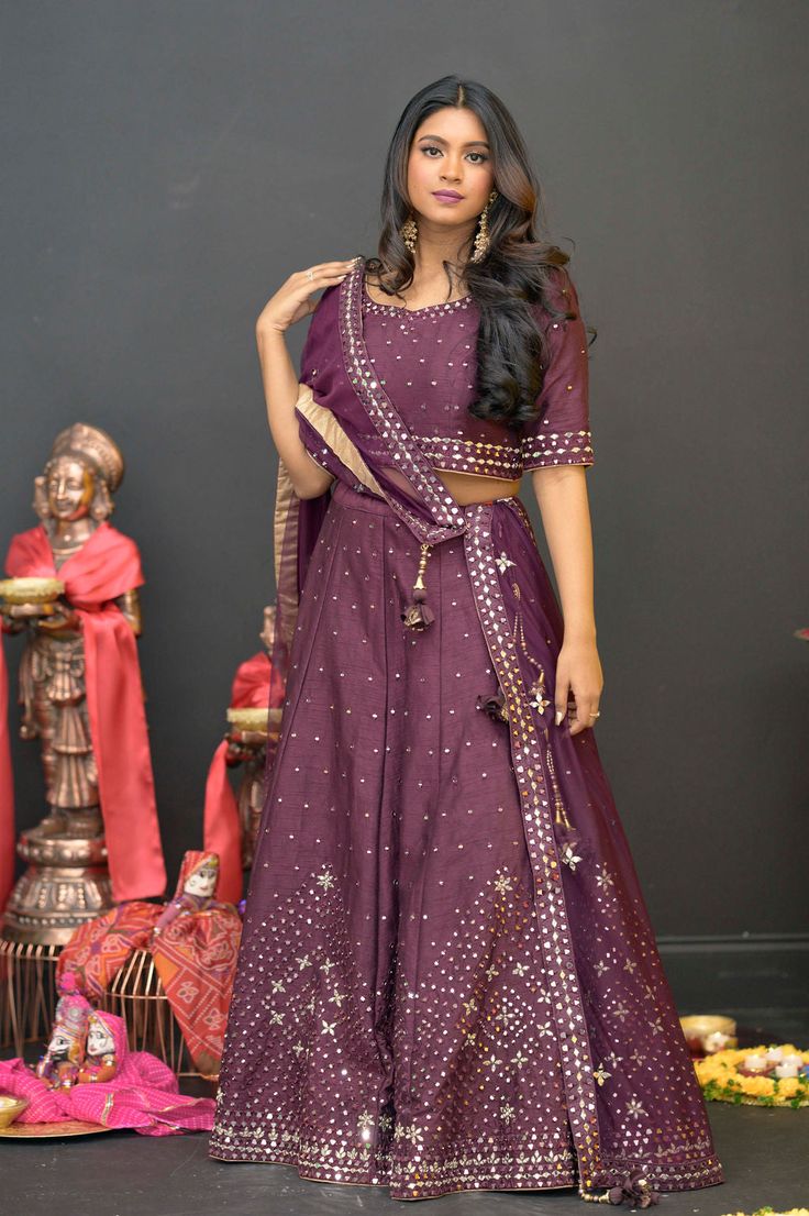 Plum Purple mirror work lehenga choli Matched with Purple mirror work blouse with quarter sleeves. Designed with round neck and has back hooks. Set together with a matching soft net purple duppata with mirror work and have gold border The length of the blouse is 14 inches. Blouse can fit a size 32 to 42 The maximum length of the lehenga will be 41 inches. Slight variation in color is possible due to digital photography. This is a 3 piece set. Care: dry clean only We provide side fitting/sleeves Mirror Work Lehenga Choli, Mirror Work Lehenga, Mirror Work Blouse, Work Lehenga, Purple Mirror, Gold Border, Plum Purple, Mirror Work, Work Blouse