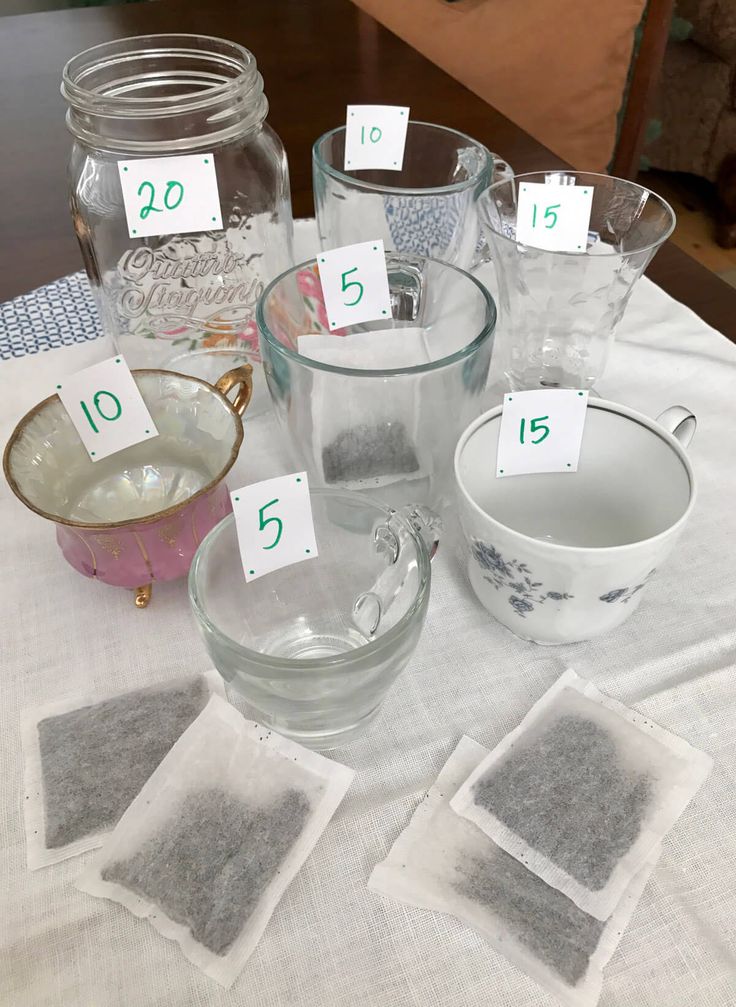 the table is set up with glass dishes and place cards for each individual to use