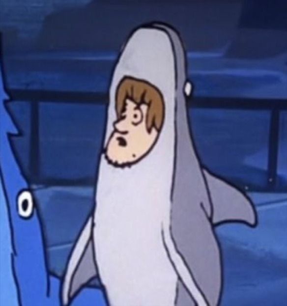 a cartoon character dressed as a shark with a man in the middle looking at it