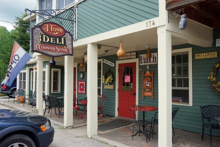 the outside of a restaurant with tables and chairs