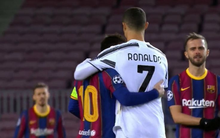 two soccer players hugging each other in front of the crowd