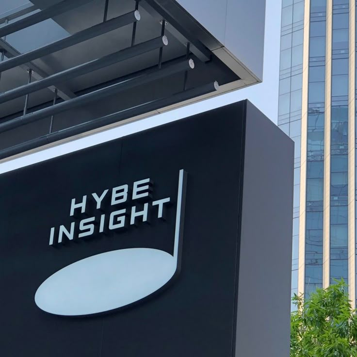 the hybe insight logo is displayed on an office building