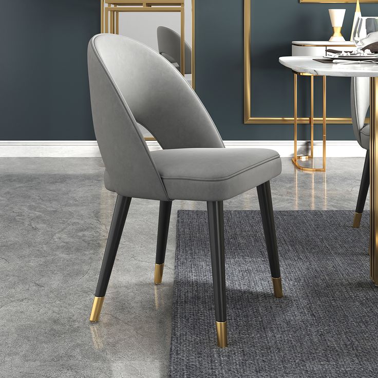 a white chair sitting next to a table on top of a gray carpeted floor