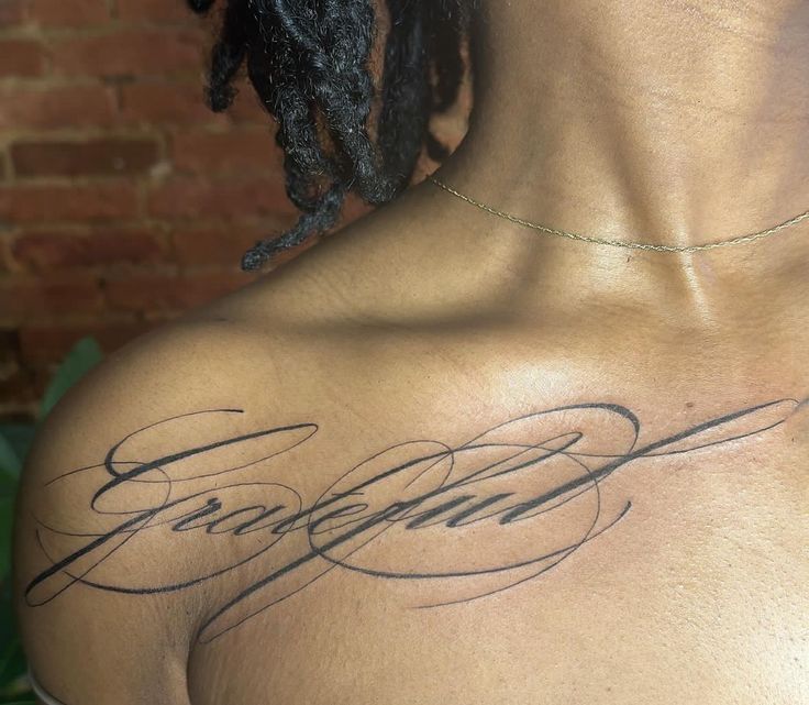 the back of a man's shoulder with his name on it and some writing in cursive ink