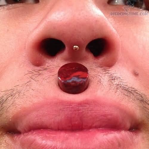 a man with a nose piercing on his nose