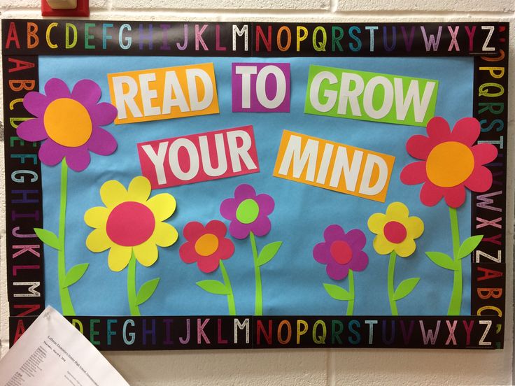 a bulletin board with flowers on it and the words read to grow your mind written in large letters